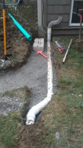 a white color pipe and other tools on the ground